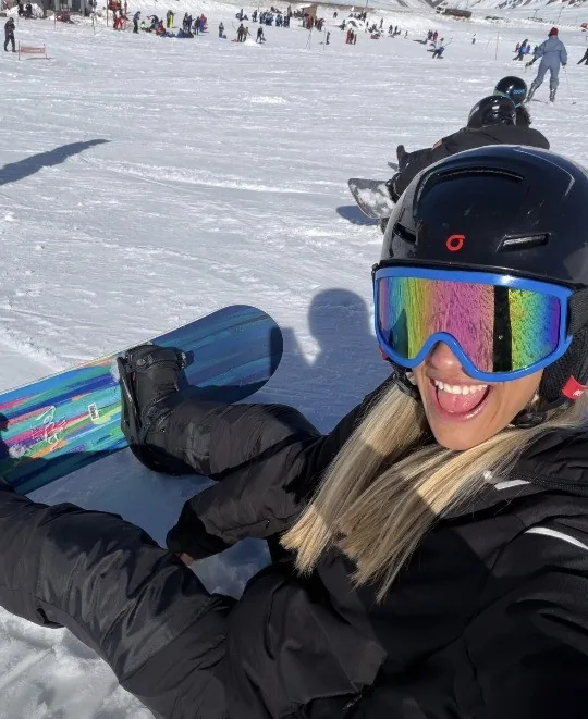Marti con la tabla de snowboard en la montaña